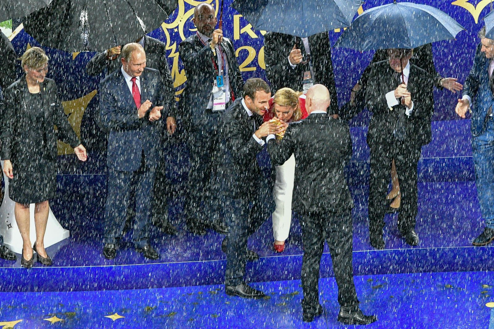 Nevjerojatne fotografije nakon finala: Kolinda i Macron mokri do kože ljube pehar